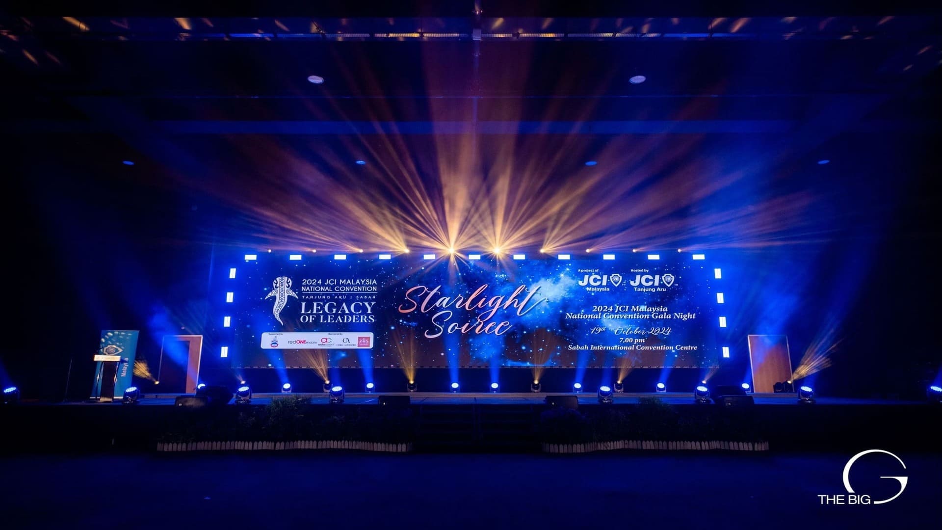 JCI Starlight Soiree stage with dramatic blue lighting setup